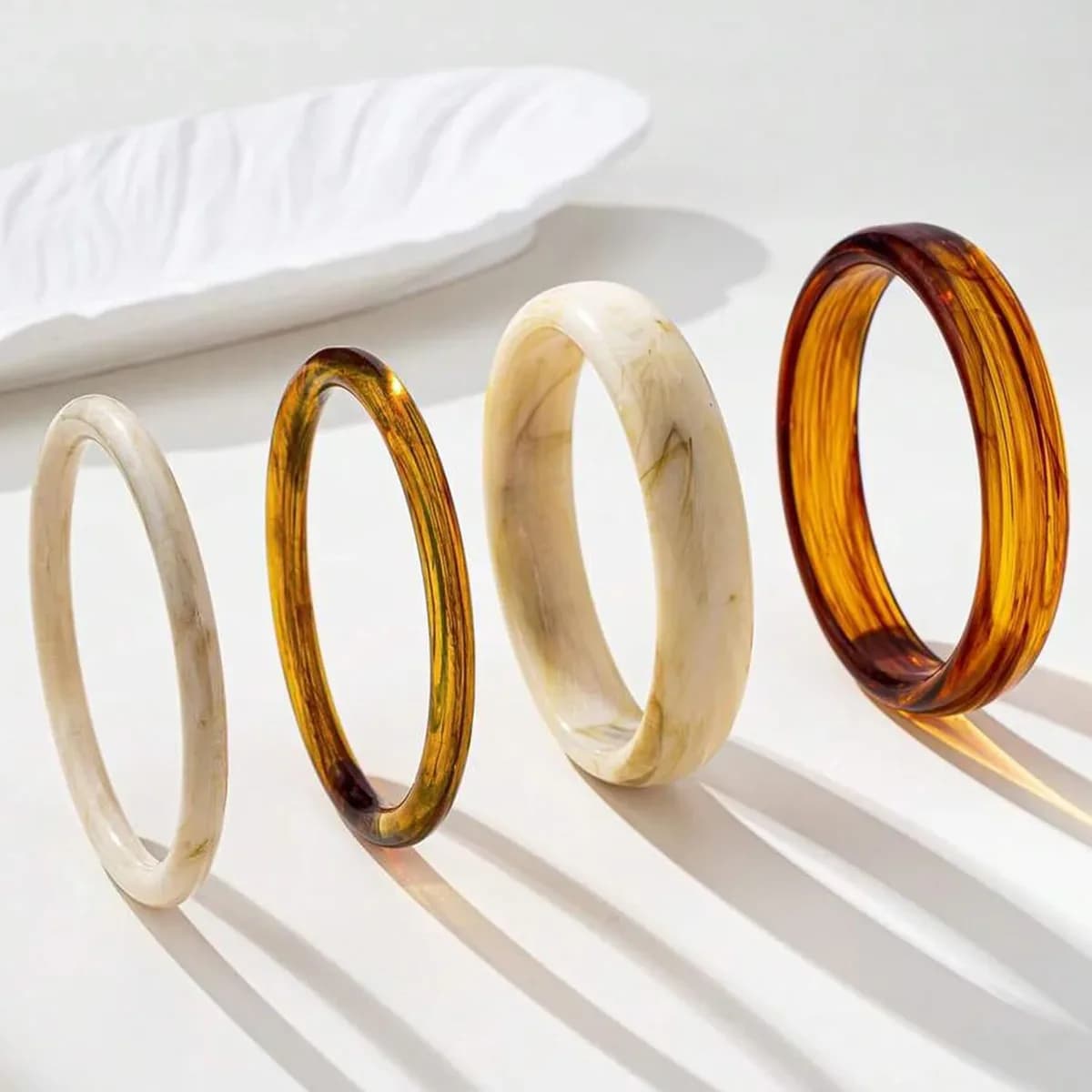 Chunky resin bangles laid out side by side to show each width