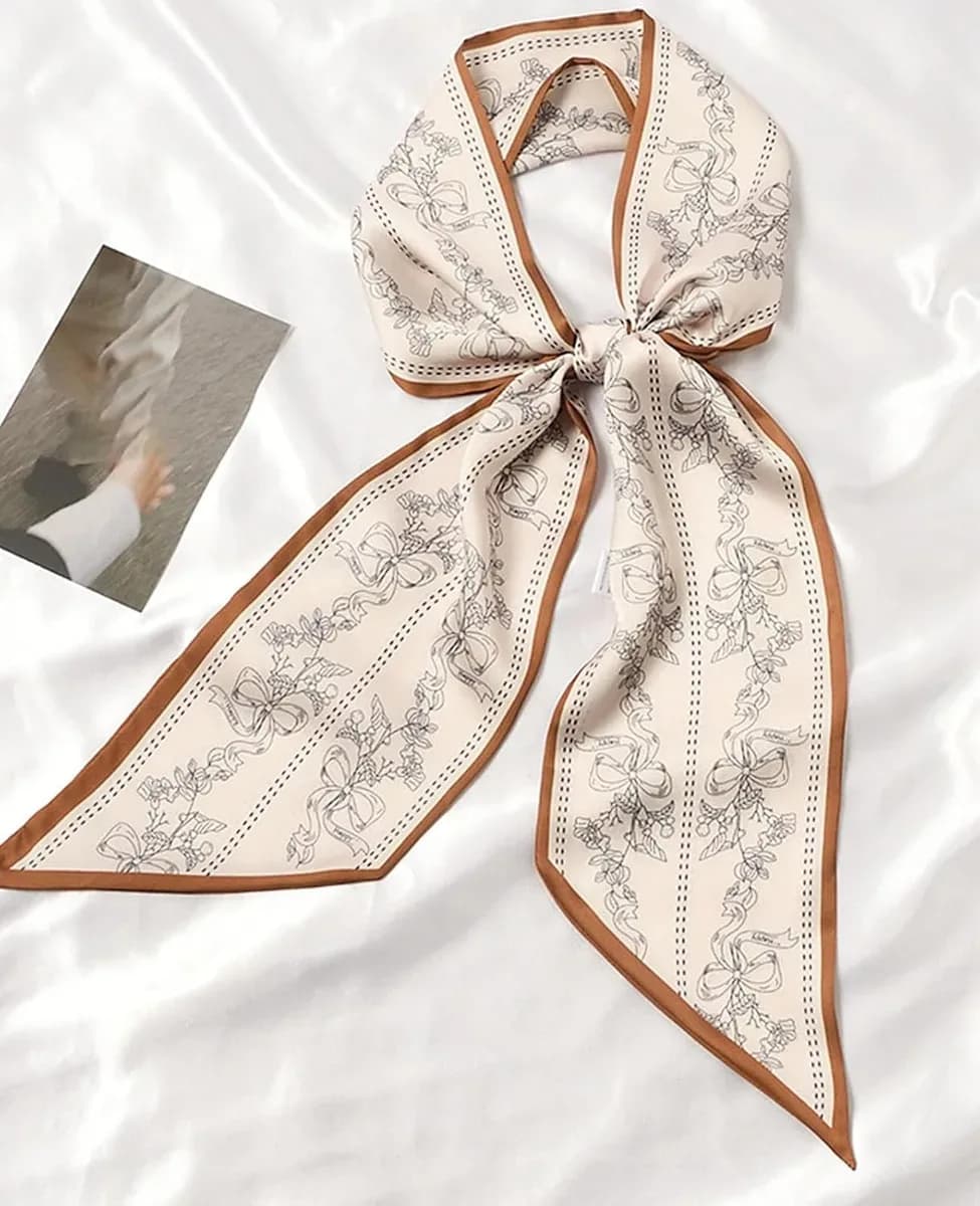 Skinny satin scarf tied in a neat bow
