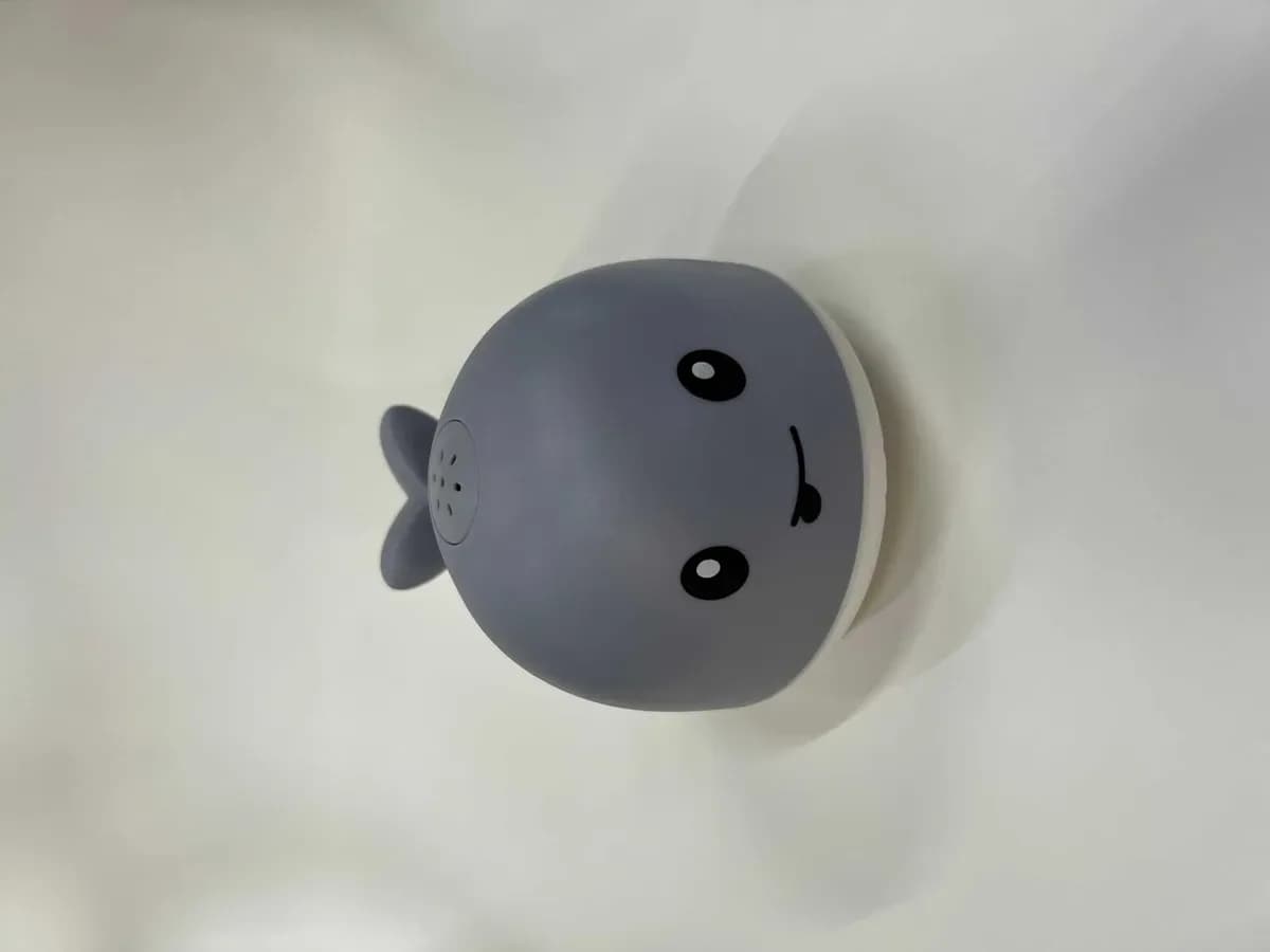 Grey light-up whale bath toy shown on its own