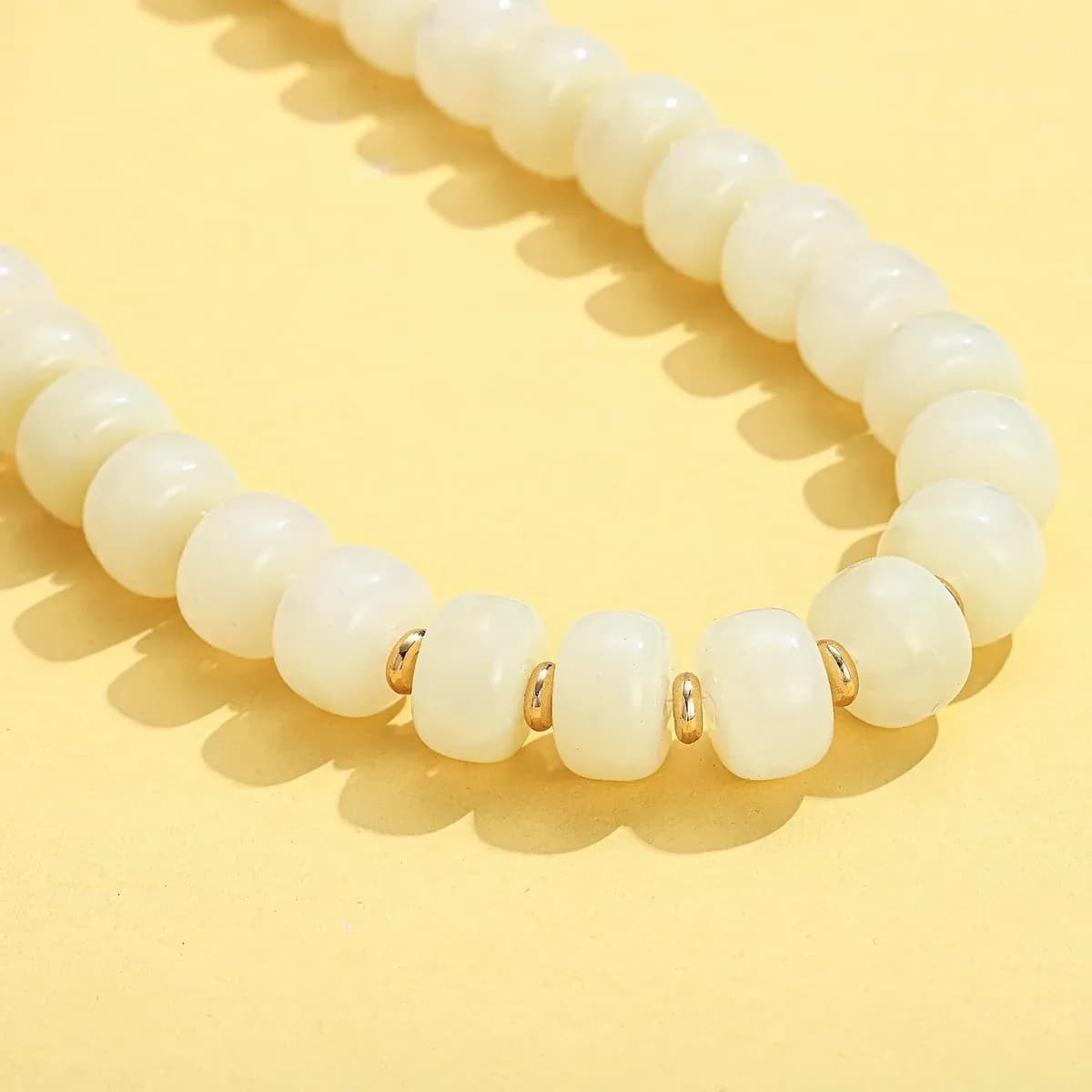 Glossy white resin beads of the chunky beaded necklace